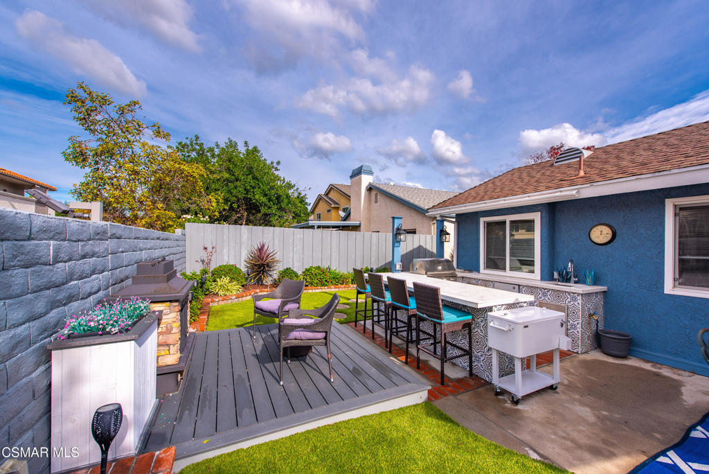 2497 Orangewood Place Simi Valley, CA 93065 - Photo 36 of 42 a view of a chairs and table in patio with wooden fence