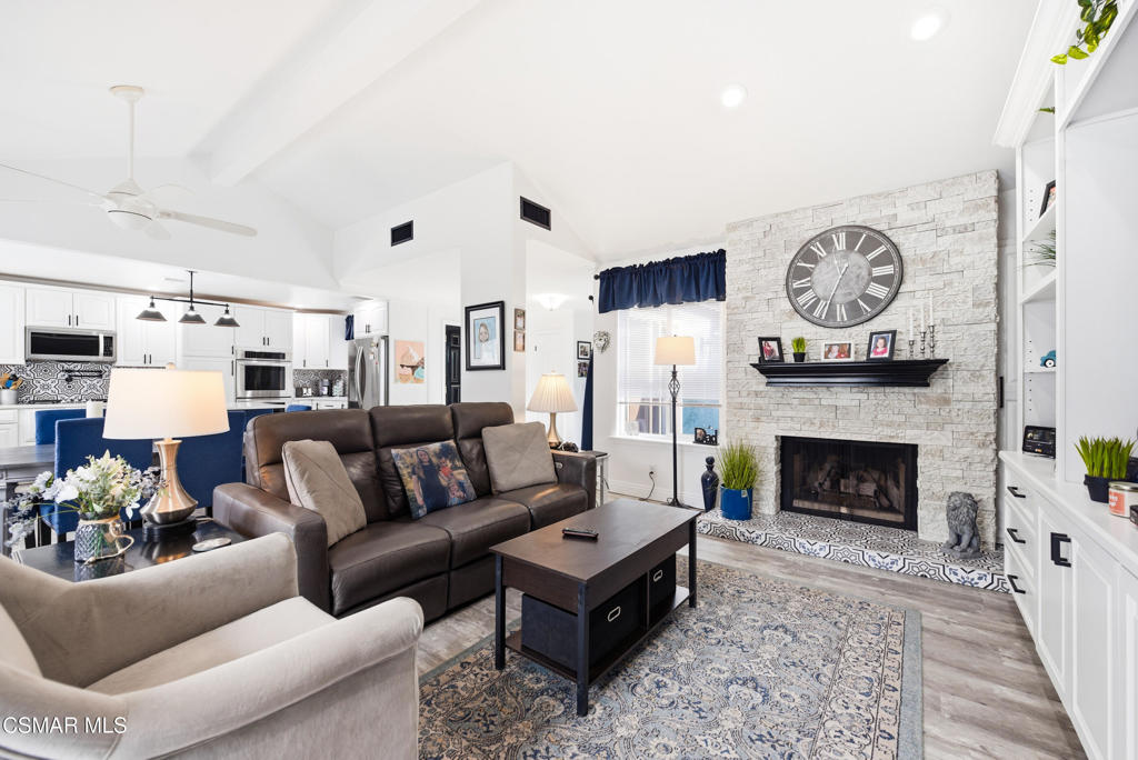 2497 Orangewood Place Simi Valley, CA 93065 - Photo 6 of 42 a living room with furniture a clock and a fireplace