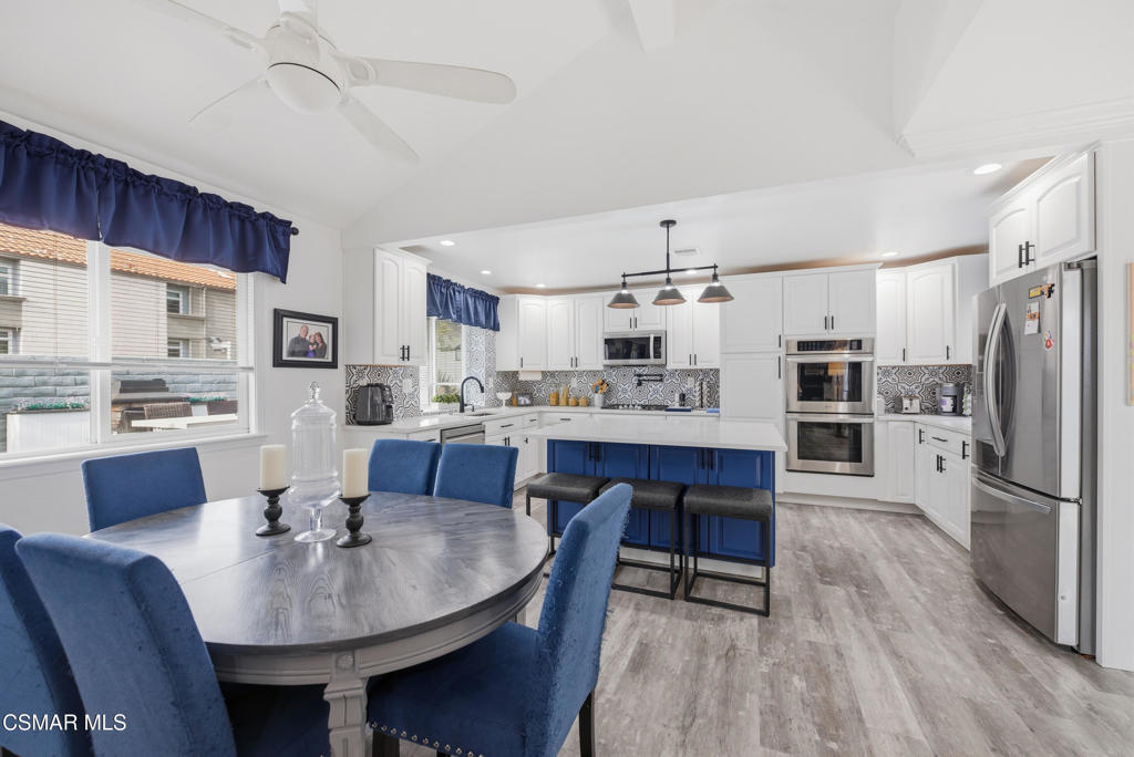2497 Orangewood Place Simi Valley, CA 93065 - Photo 9 of 42 a kitchen with refrigerator a sink and chairs