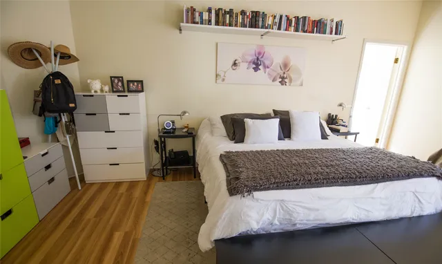 a bedroom with a bed and a flat screen tv
