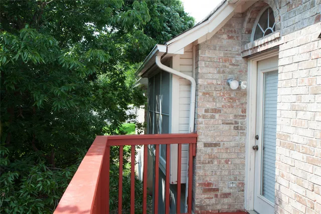a view of a patio with a table chairs and a barbeque