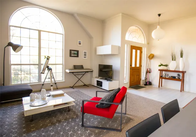 a living room with furniture a fireplace and a table