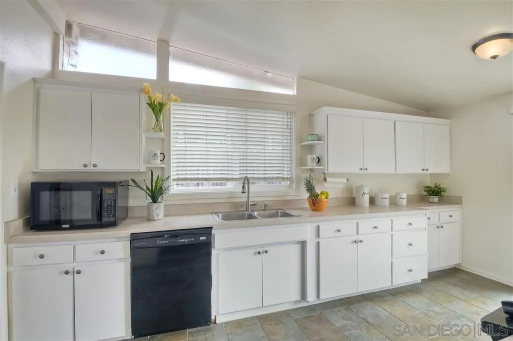 13733 Powers Road Poway, CA 92064 - Photo 8 of 23 a kitchen with granite countertop a sink a stove and cabinets
