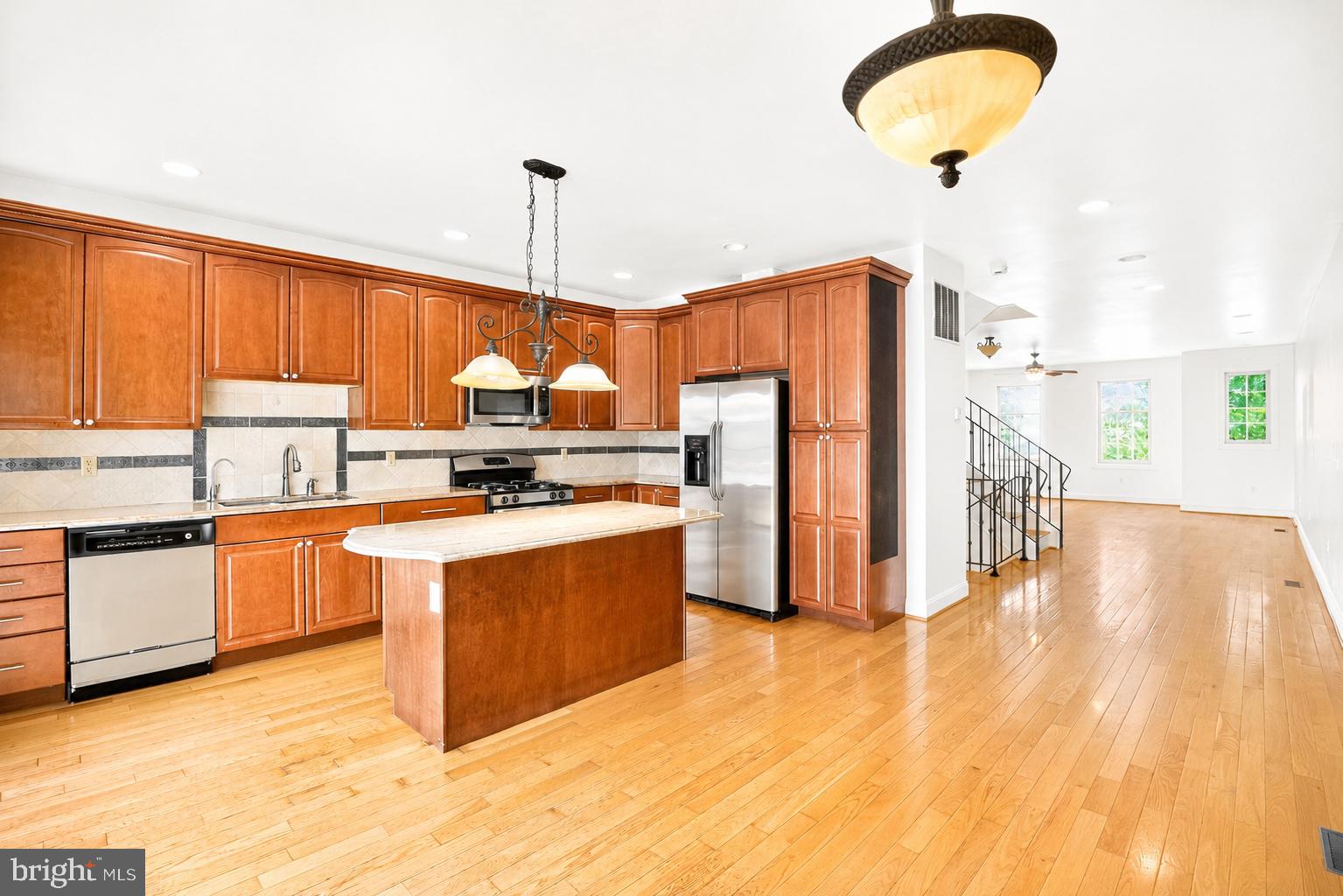 493 Harmon Road, Unit F Philadelphia, PA 19128 - Photo 2 of 38 Modern kitchen with warm wood accents.