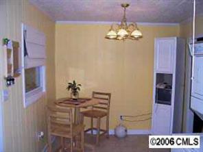 695 Sunderland Road Southwest Concord, NC 28027 - Photo 6 of 8 a dining room with furniture and chandelier