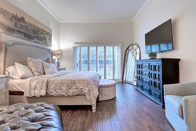 a bedroom with bed and wooden floor