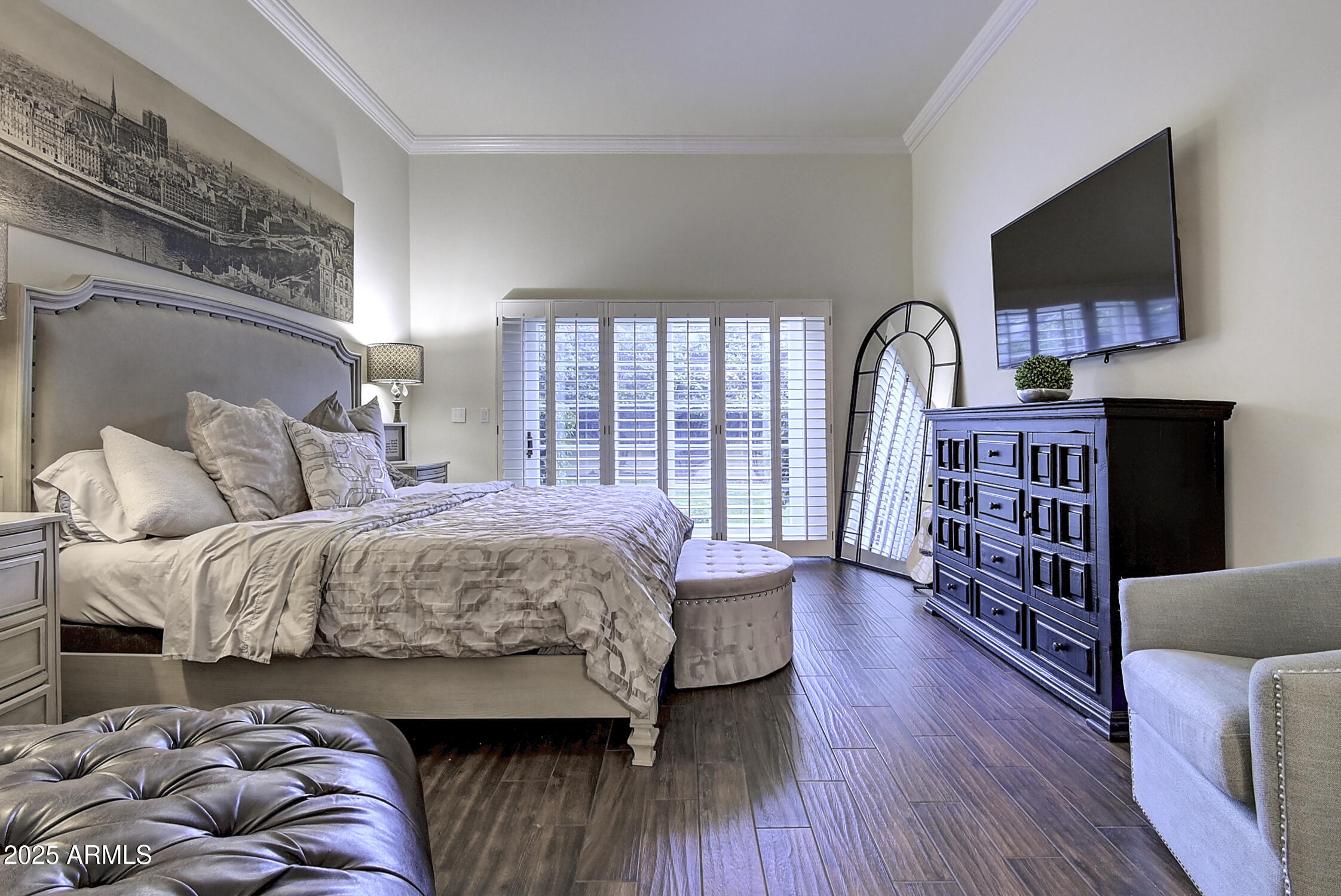 3050 East Marlette Avenue Phoenix, AZ 85016 - Photo 17 of 54 a bedroom with a large bed a flat tv screen and a bookshelf