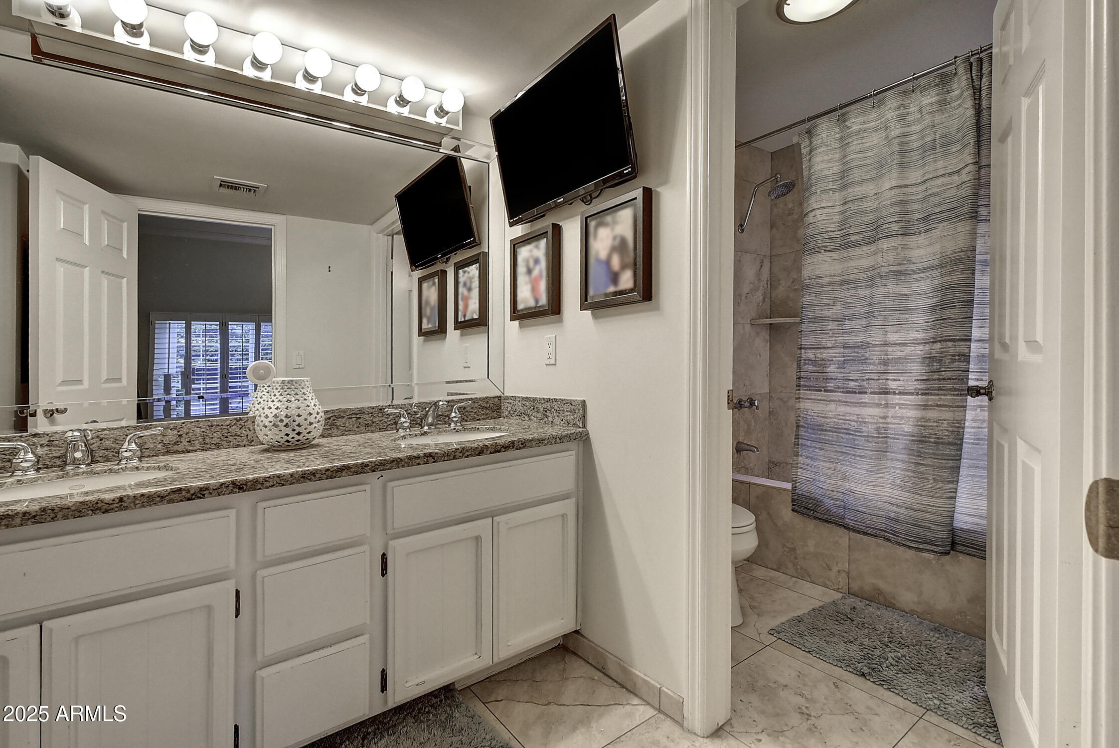 3050 East Marlette Avenue Phoenix, AZ 85016 - Photo 20 of 54 a bathroom with a double vanity sink and mirror