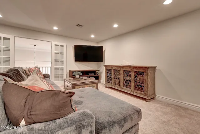 a large bedroom with a bed and a flat screen tv