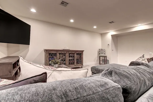 a living room with furniture a fireplace and a flat screen tv