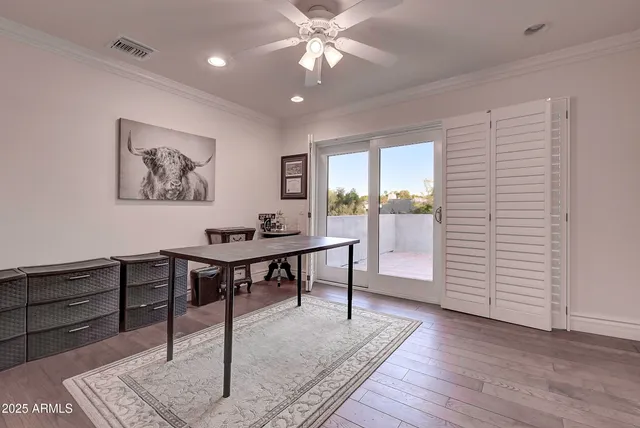 a kitchen with stainless steel appliances wooden floor and wooden cabinets