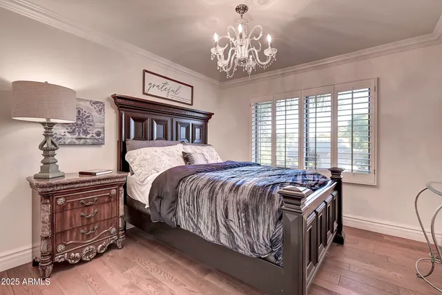a bedroom with two beds and a chandelier