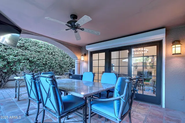 a view of a patio with a table and chairs