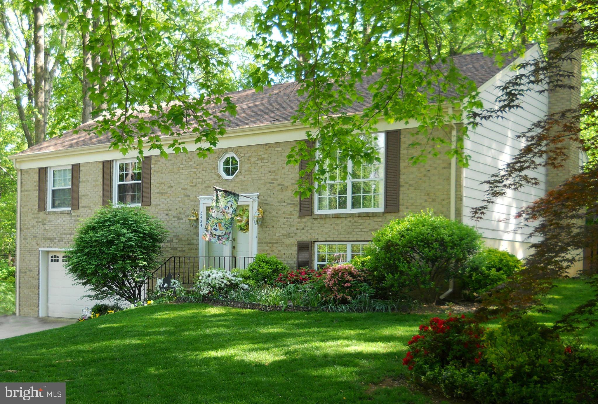 8425 Blevins Way Court Vienna, VA 22182 - Photo 1 of 30 a front view of a house with a garden