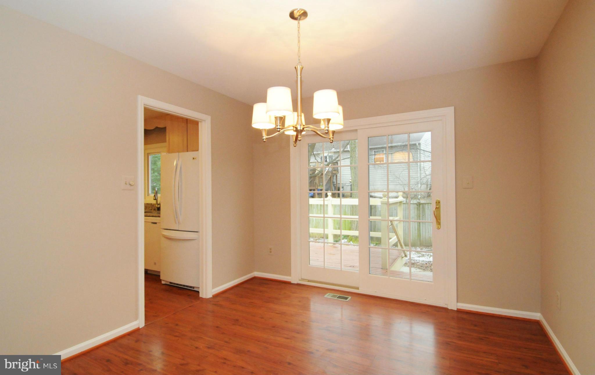 8425 Blevins Way Court Vienna, VA 22182 - Photo 12 of 30 a view of a room with wooden floor and large window