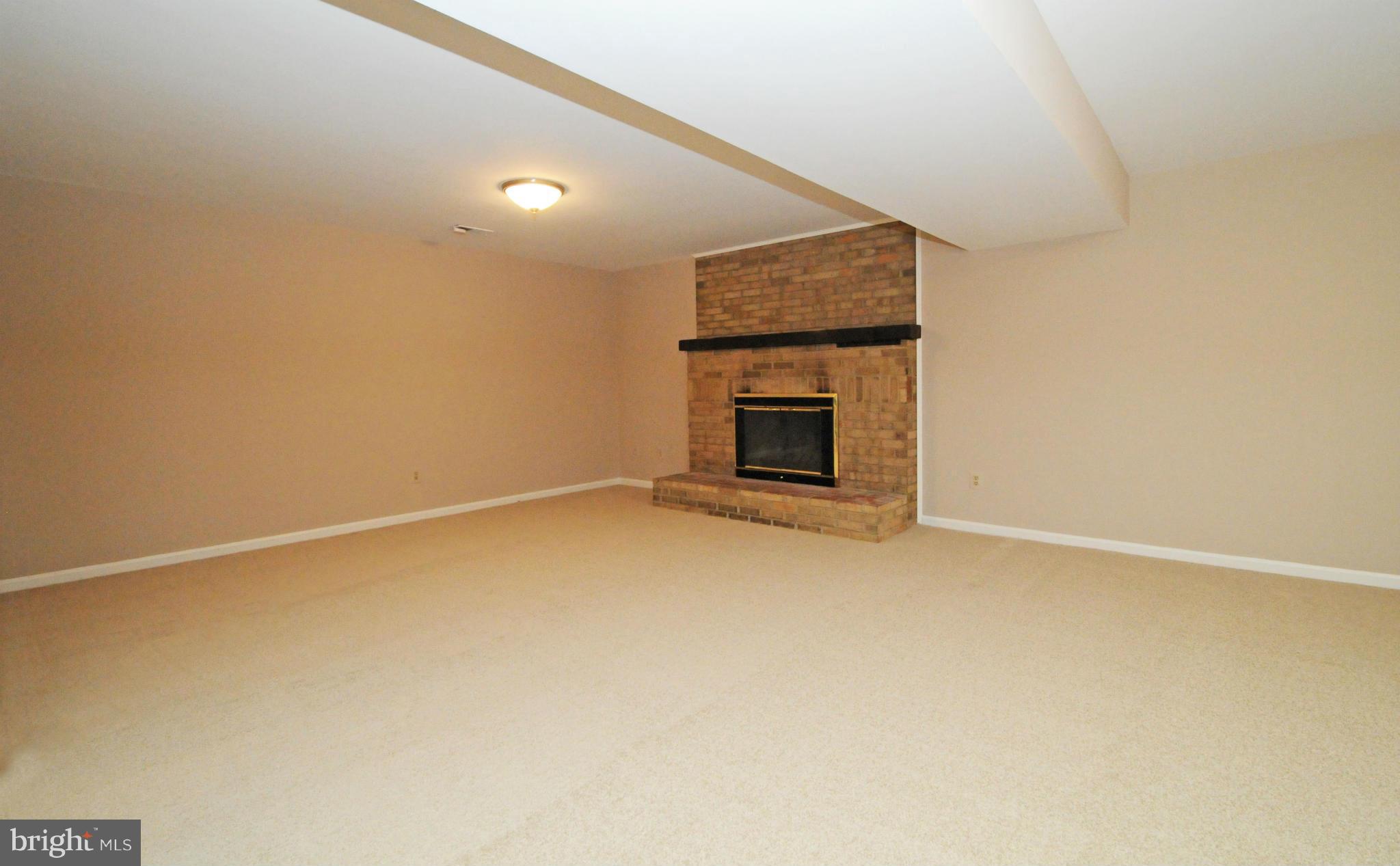 8425 Blevins Way Court Vienna, VA 22182 - Photo 27 of 30 a view of empty room with a fireplace
