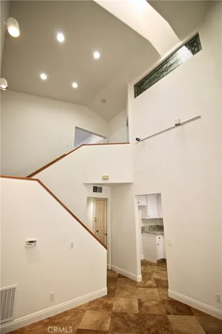 a view of a kitchen with a sink and refrigerator