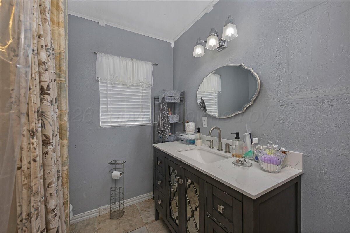 4011 Parker Street Amarillo, TX 79110 - Photo 11 of 17 a bathroom with a sink vanity and a mirror