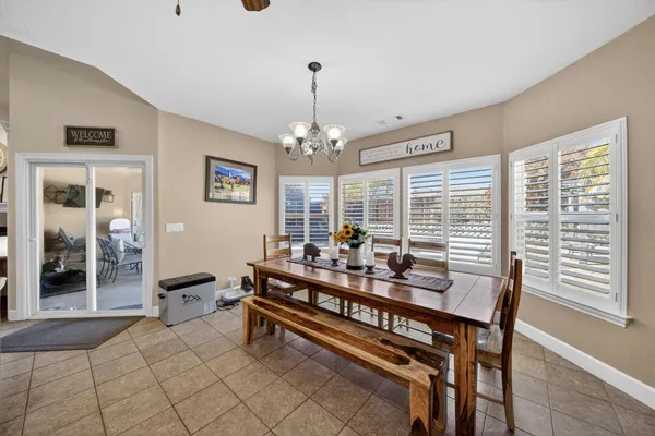 a view of a dining room with furniture and chandelier