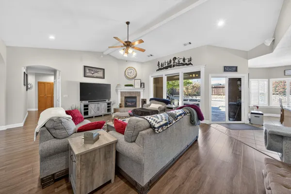 a living room with furniture a flat screen tv and a large window