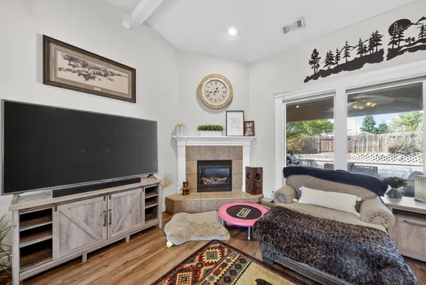a living room with furniture a flat screen tv and a fireplace