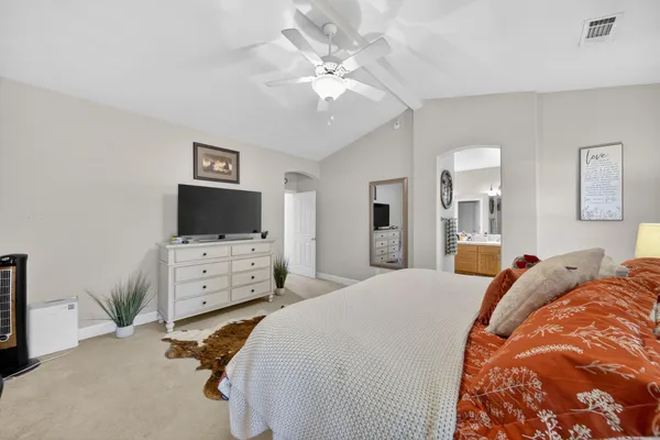 a bedroom with furniture and flat screen tv
