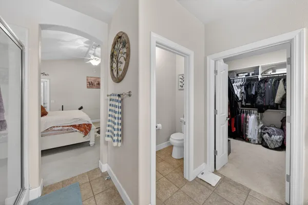 a en suite bathroom with a toilet tub and a view of bedroom
