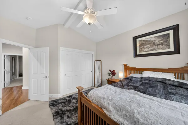 a bedroom with a large bed and a chandelier