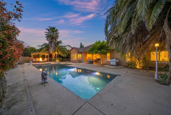 a view of a swimming pool with an outdoor seating