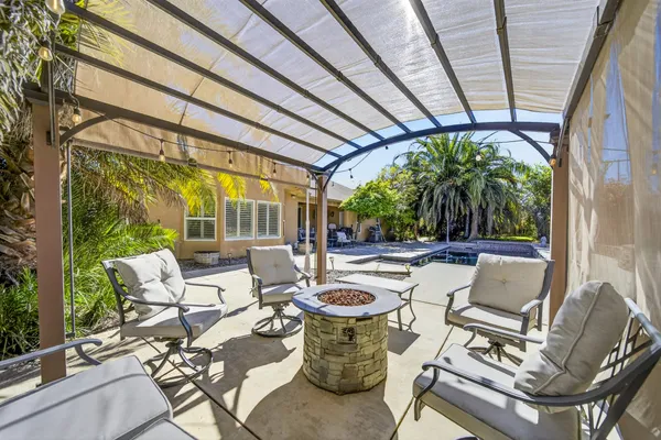 a view of an outdoor sitting area with furniture and floor to ceiling window