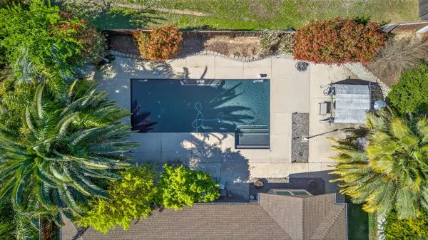 an aerial view of a house with a yard and trees