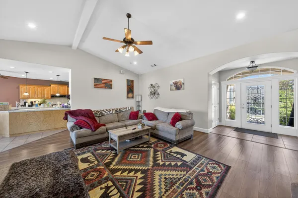 a living room with furniture and wooden floor