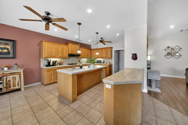a kitchen with a sink appliances and cabinets