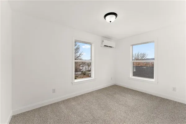 an empty room with windows and closet