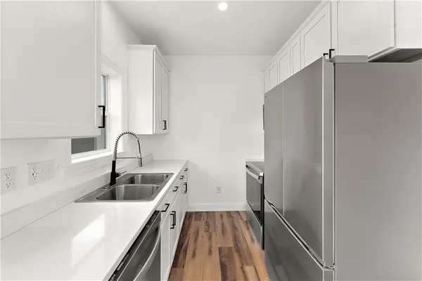 a kitchen with a sink and refrigerator