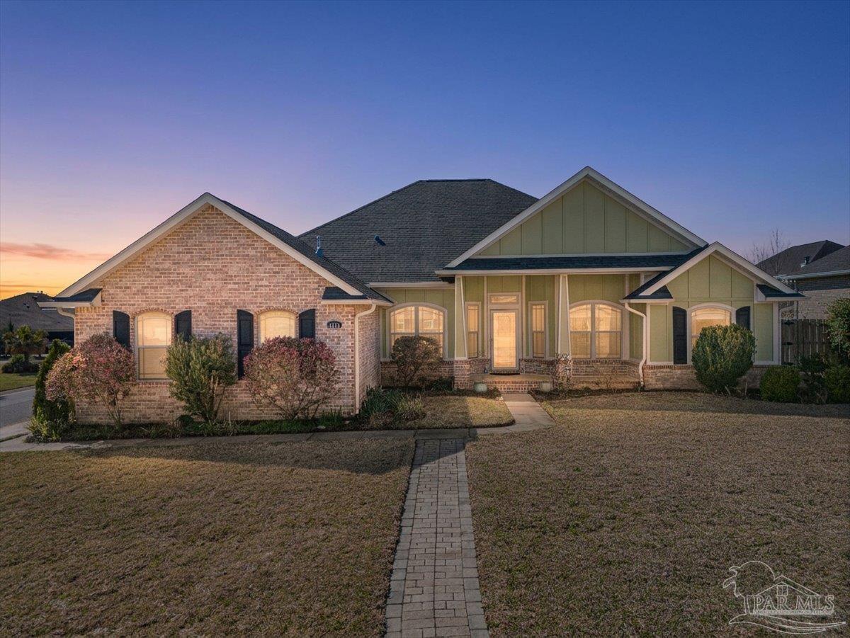 5997 Stonechase Boulevard Pace, FL 32571 - Photo 1 of 52 a front view of a house with a yard