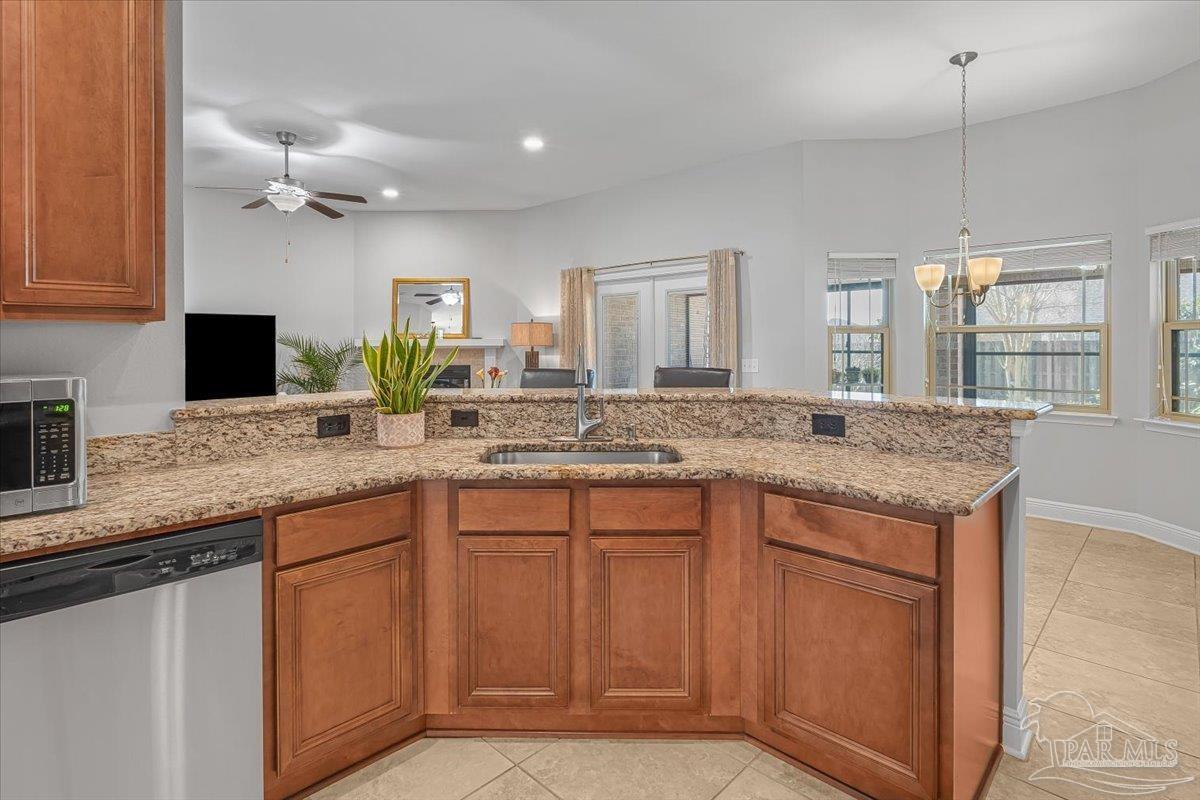 5997 Stonechase Boulevard Pace, FL 32571 - Photo 14 of 52 a kitchen with center island and sink