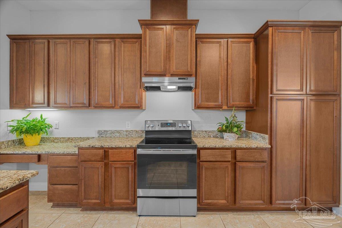 5997 Stonechase Boulevard Pace, FL 32571 - Photo 15 of 52 a kitchen with a stove top oven cabinetry and garage