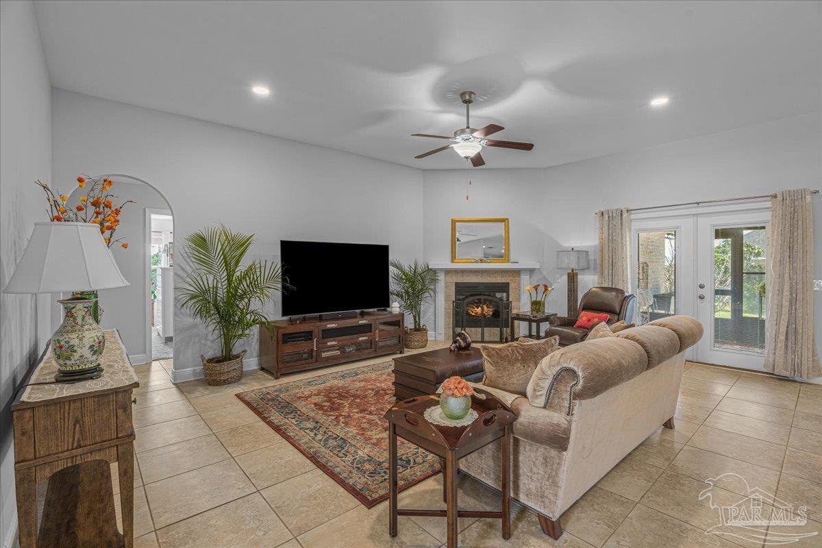 5997 Stonechase Boulevard Pace, FL 32571 - Photo 21 of 52 a living room with furniture a fireplace and a flat screen tv