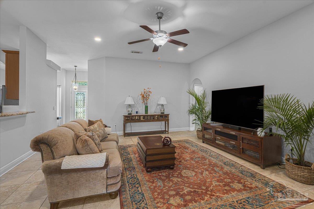 5997 Stonechase Boulevard Pace, FL 32571 - Photo 22 of 52 a living room with furniture and a flat screen tv