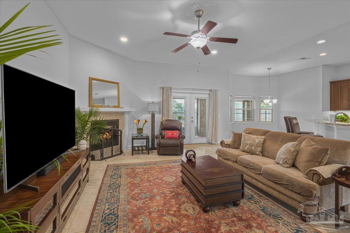 5997 Stonechase Boulevard Pace, FL 32571 - Photo 23 of 52 a living room with furniture a flat screen tv and a fireplace