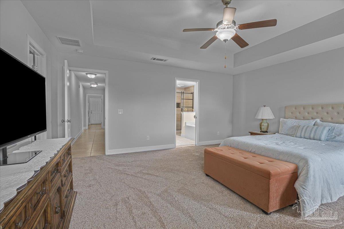 5997 Stonechase Boulevard Pace, FL 32571 - Photo 28 of 52 a spacious bedroom with a bed and a flat screen tv