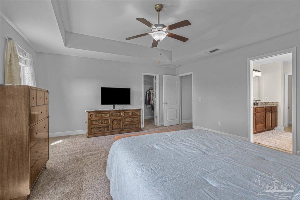 5997 Stonechase Boulevard Pace, FL 32571 - Photo 29 of 52 a bedroom with a bed and a flat screen tv