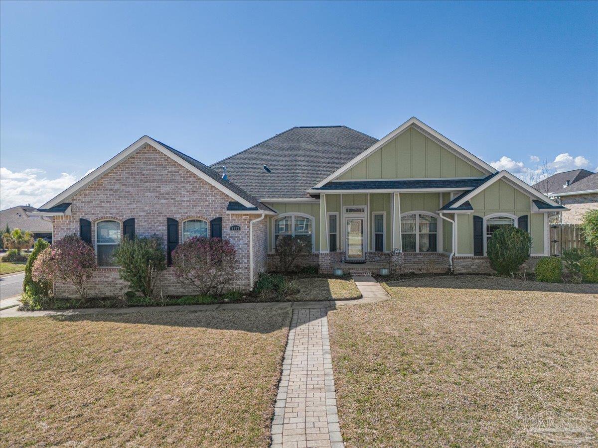 5997 Stonechase Boulevard Pace, FL 32571 - Photo 3 of 52 a front view of a house with a yard