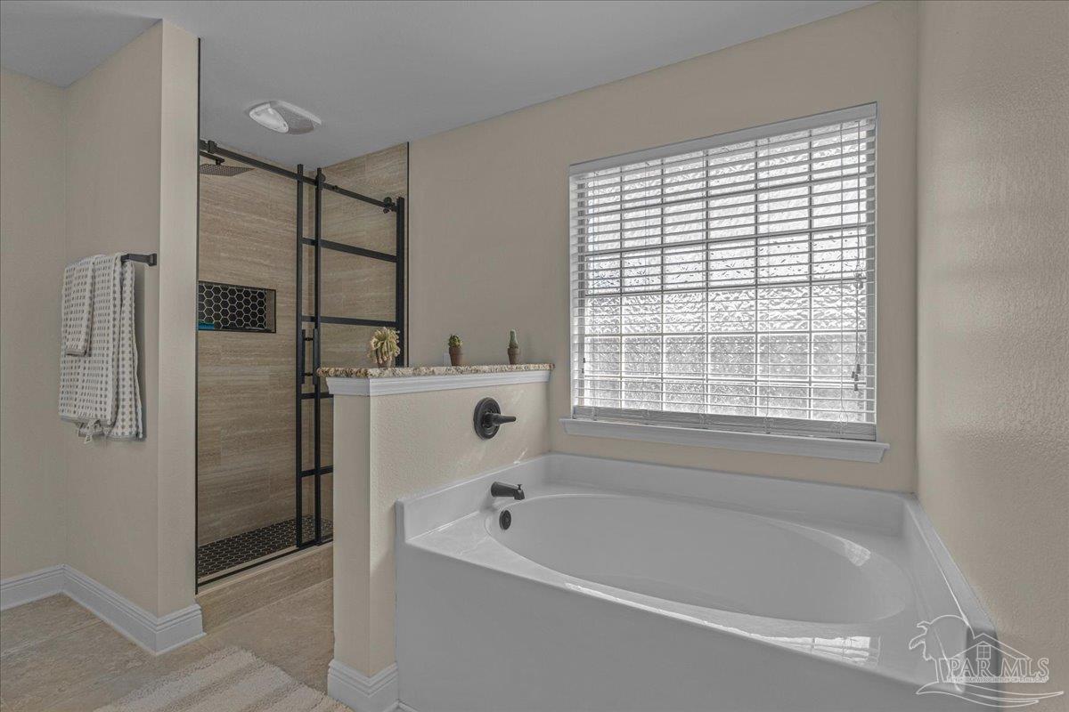 5997 Stonechase Boulevard Pace, FL 32571 - Photo 32 of 52 a white bath tub sitting next to a window