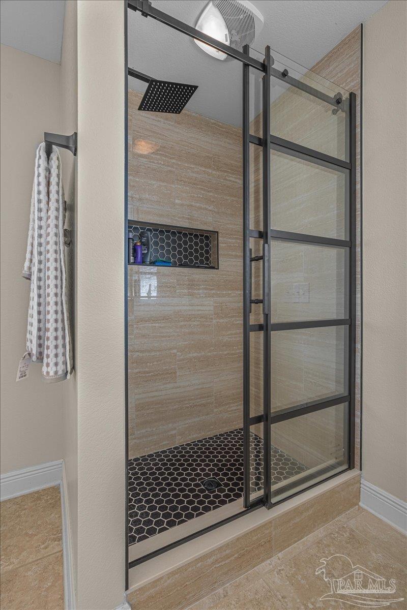 5997 Stonechase Boulevard Pace, FL 32571 - Photo 33 of 52 a bathroom with a glass shower door