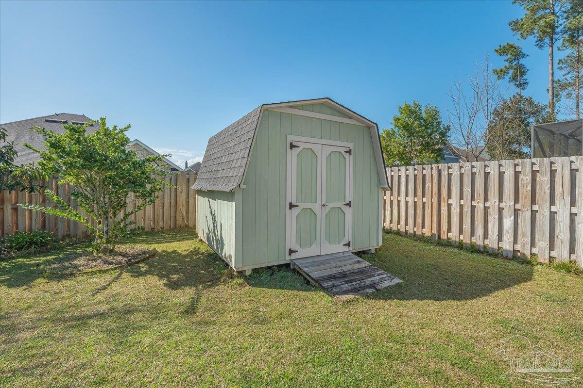 5997 Stonechase Boulevard Pace, FL 32571 - Photo 46 of 52 a view of a house with a small yard and wooden fence