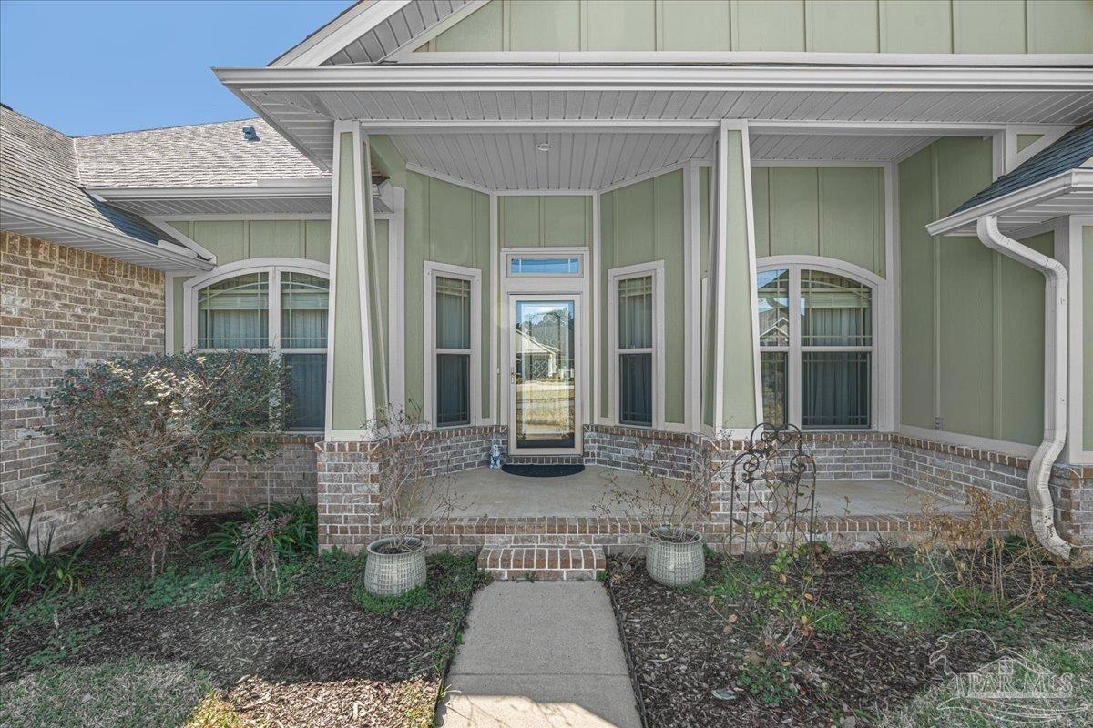 5997 Stonechase Boulevard Pace, FL 32571 - Photo 7 of 52 a view of house with backyard porch and outdoor space