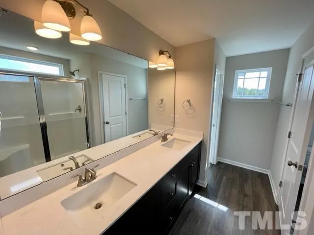 a bathroom with a sink double vanity granite and a mirror