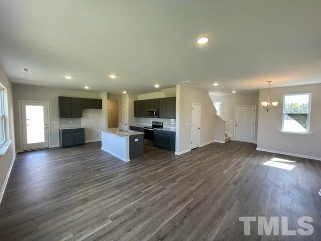 a view of a kitchen with a sink and a stove top oven